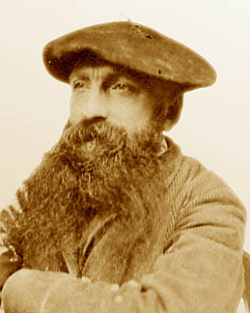 Photo of Rodin wearing a beret, looking into the distance.