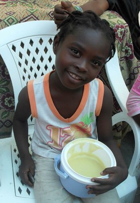 Haiti Girl in community centre happy to be fed