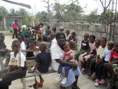 Community children waiting patiently in hope of food