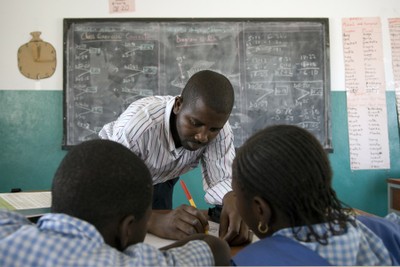 Pupils and teacher in front of blackboard, Basse