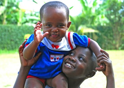 Girl carrying child, SOS Children's Village Fort Portal, Uganda